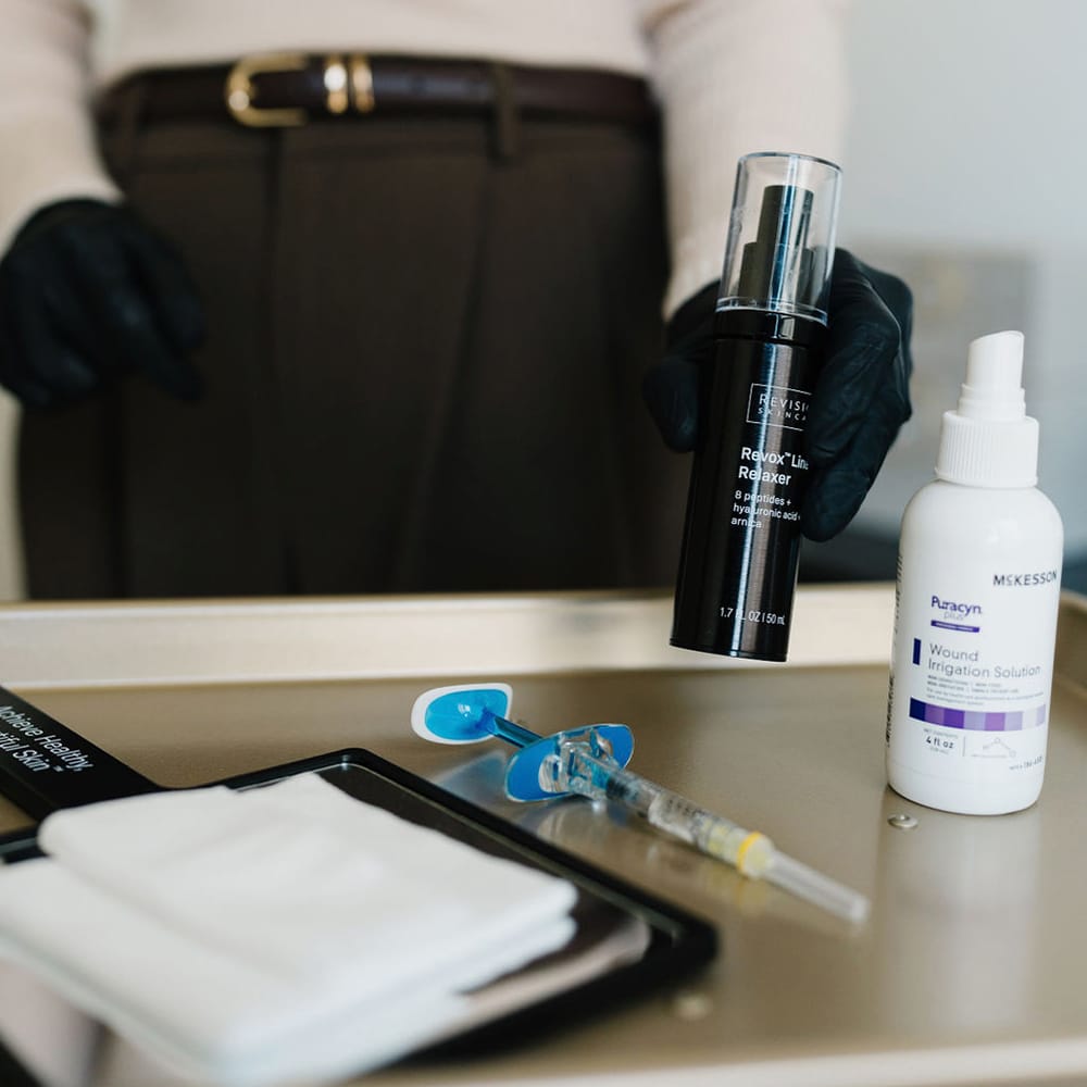a bottle of items sitting on a desk